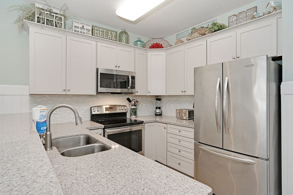 Your fully equipped kitchen features modern appliances and plenty of counter space for cooking meals together.