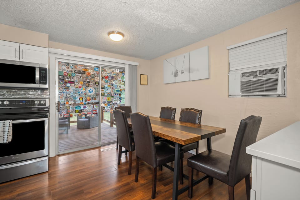 Bright dining area with patio access, comfy seating, and A/C