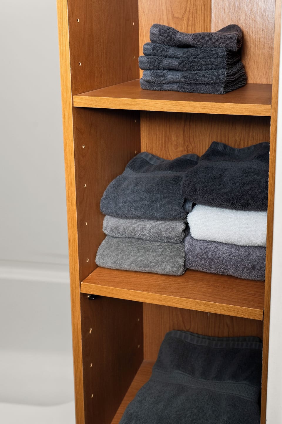 Fresh folded towels on open shelving for a clean, guest-ready stay