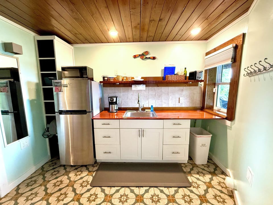 Refrigerator, sink, microwave, hot plate, coffee maker, toaster, dishware,pantry
