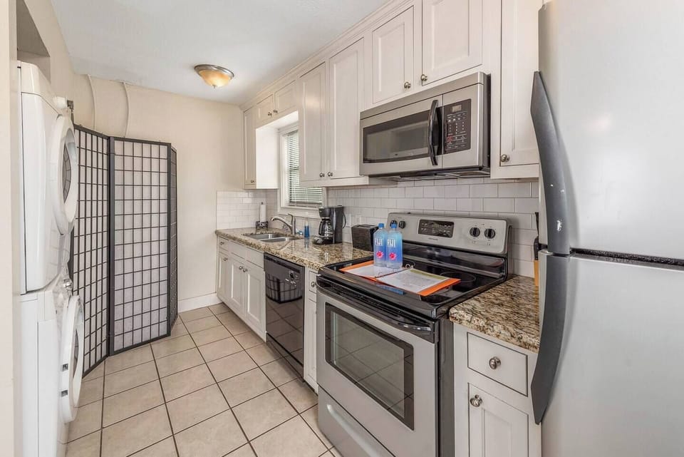 full kitchen with cooking utensils (pots, pans, etc.) there is a toaster and coffee maker along with coffee in the cabinet.