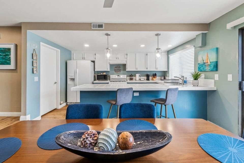 View looking over the dining room towards the kitchen. The laundry room is through the door next to the refrigerator. 
