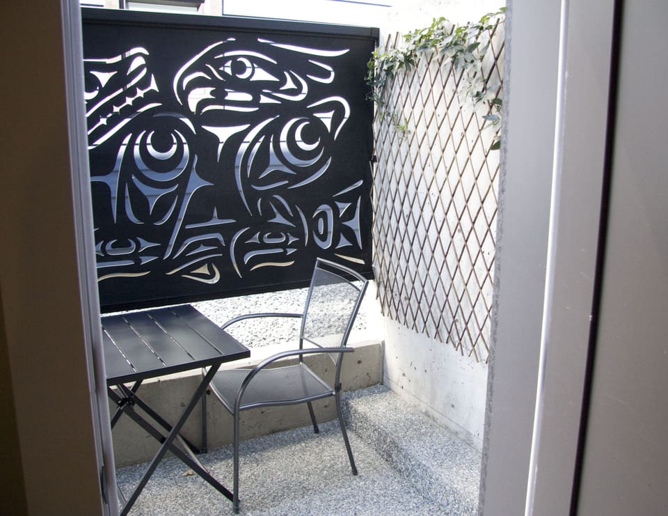Outdoor dining area with Coast Salish Privacy Screen