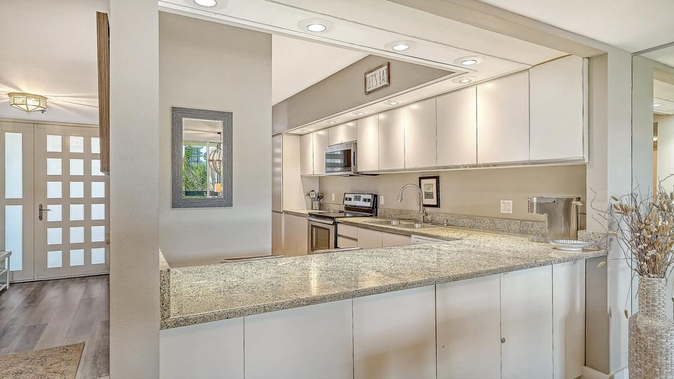 Bright, open kitchen with sleek granite countertops and modern appliances