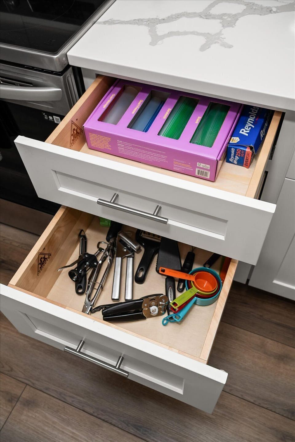 Well-stocked kitchen drawers with cooking tools and food storage basics