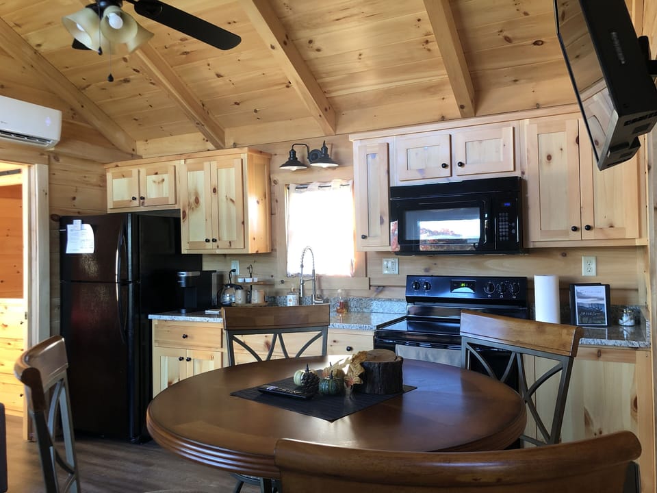 Full kitchen with refrigerator, oven and microwave. Coffee maker is a Keurig. 