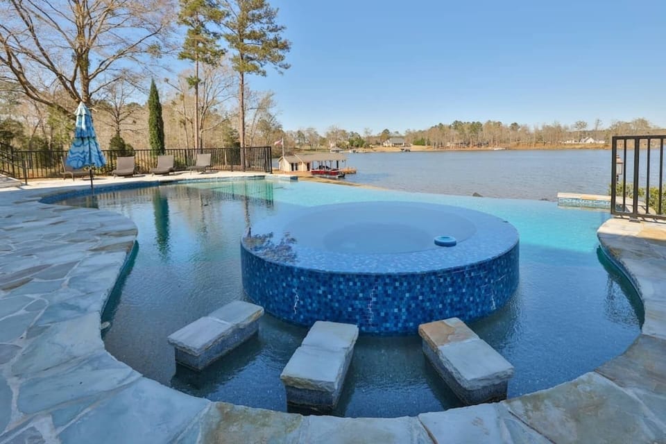 Dive into luxury with our massive infinity pool—offering stunning views of the lake for a truly serene experience.