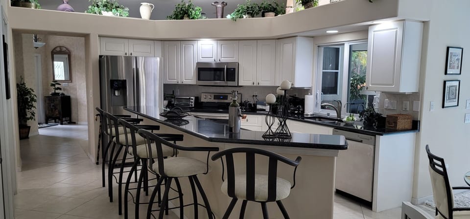 Fully equipped kitchen with breakfast bar and additional kitchen area dining