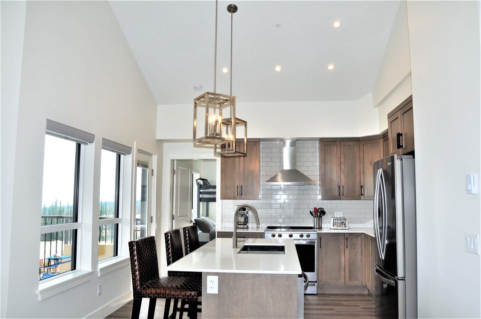 Brand new kitchen with quartz counters, large sinks, SS appliances & bar seating
