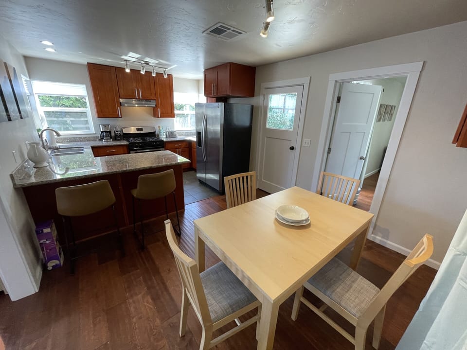Dining table with extra leaves and chairs for more seating.