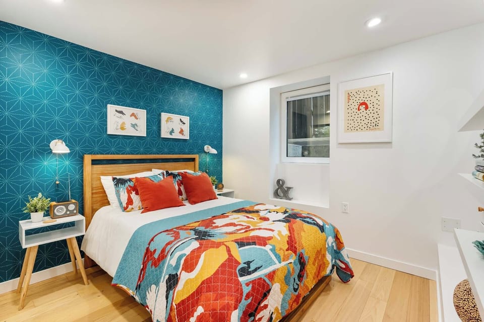 Drift off in a fun, art-filled bedroom featuring a cozy double bed with a Casper mattress, soft cotton sheets, and a soothing sound machine!