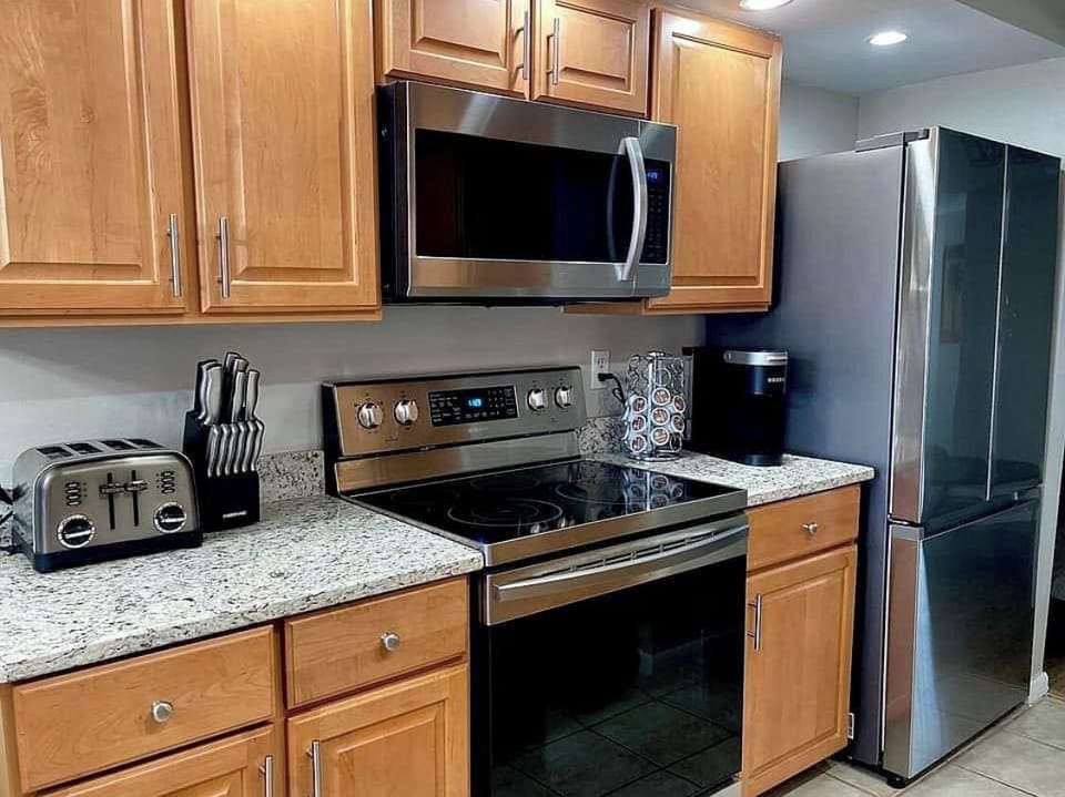 Kitchen with granite countertops and new appliances all Samsung stainless steel