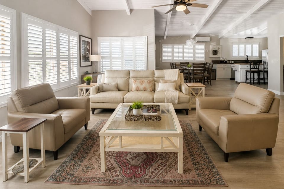 The Perfect Coastal Retreat: Unwind on the Leather Sofa, Embrace the Electric Fireplace's Warmth, and Get Lost in the Beach Views."