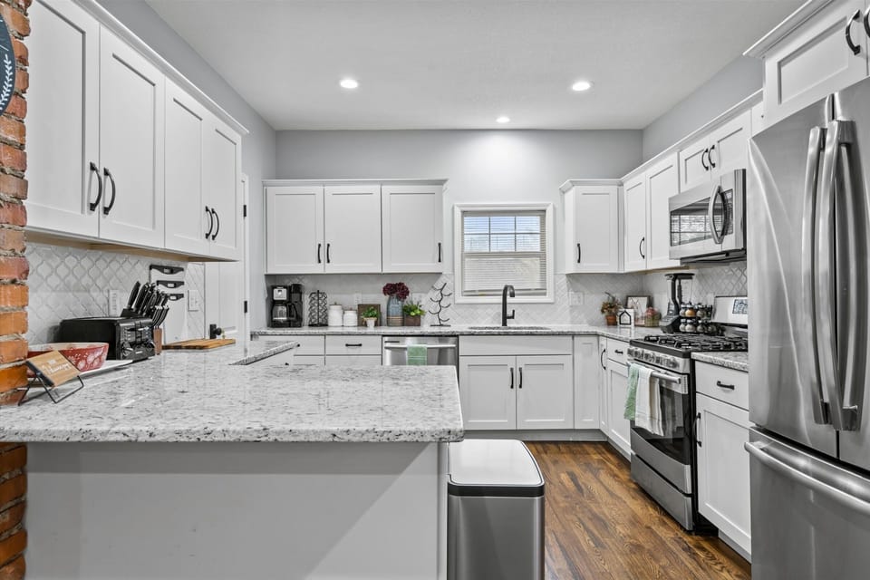 Bright, fully equipped kitchen with expansive granite counters—perfect for cooking before heading out to explore Midtown, Westport, or the Plaza.