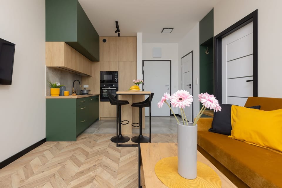 A compact kitchenette with modern appliances, colorful decor, and practical storage space.
