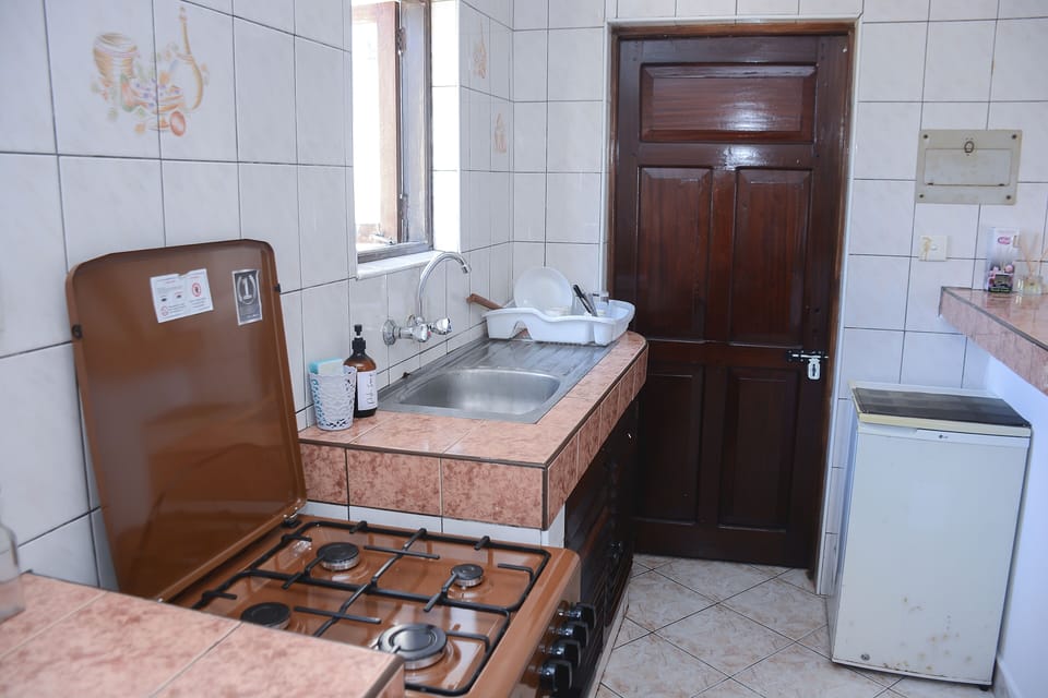 Kitchen with gas oven and mini fridge