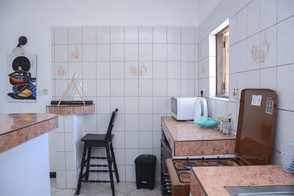 Kitchen with microwave, kettle and coffe/tea accessories 