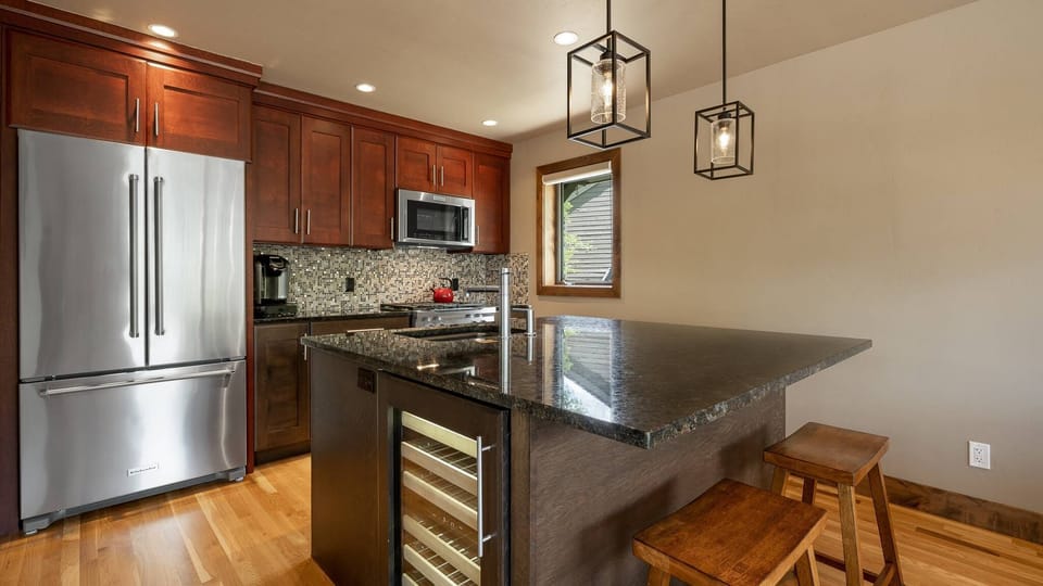 Updated kitchen with professional appliances and island seating.