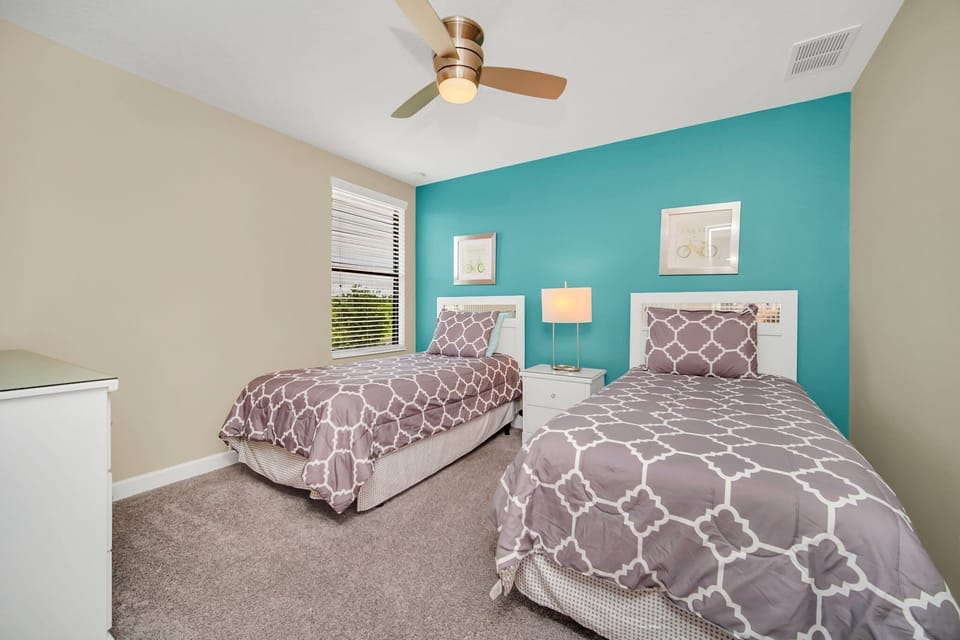 Bright and cheerful bedroom with twin beds, offering a cozy and inviting space for guests of all age