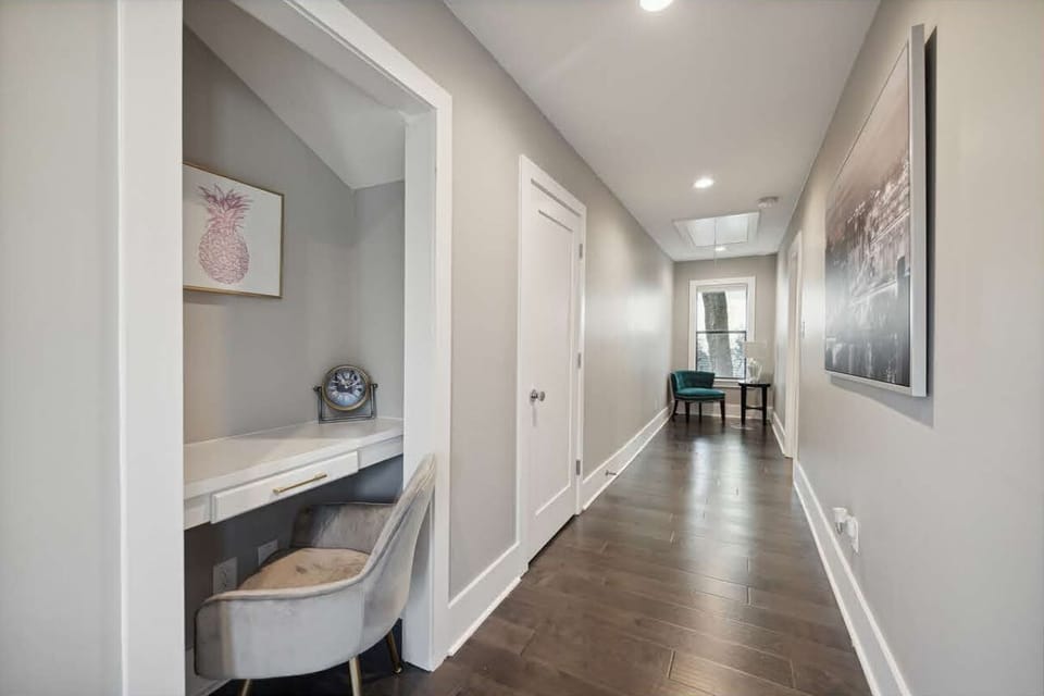 Second floor hallway with sitting and desk area.