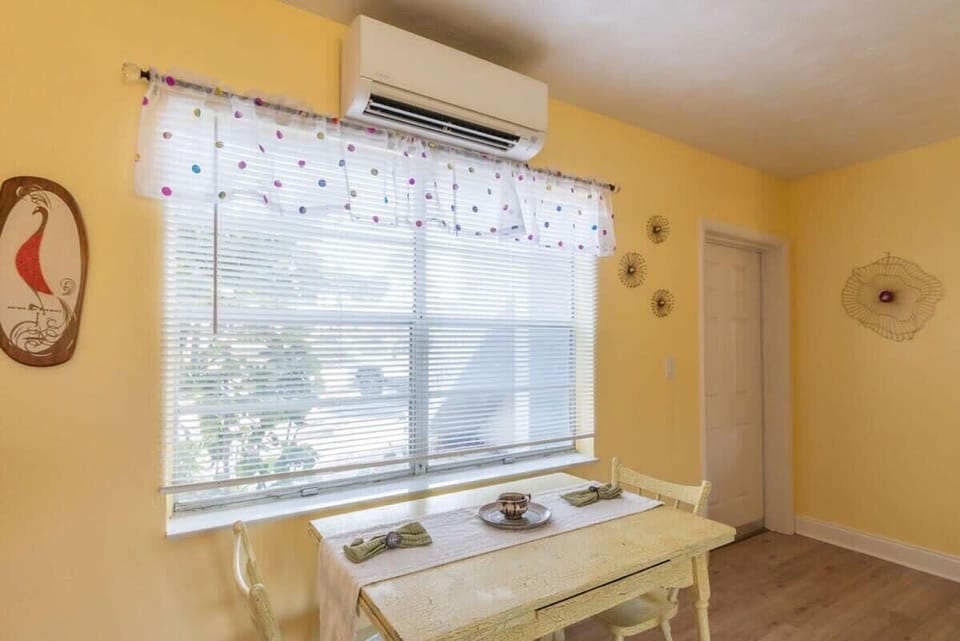 sunlit dining area with rustic table and air conditioning
