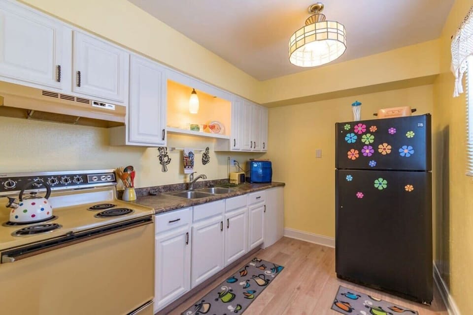 Cozy kitchen with vintage appliances and colorful decor for a cheerful cooking experience.
