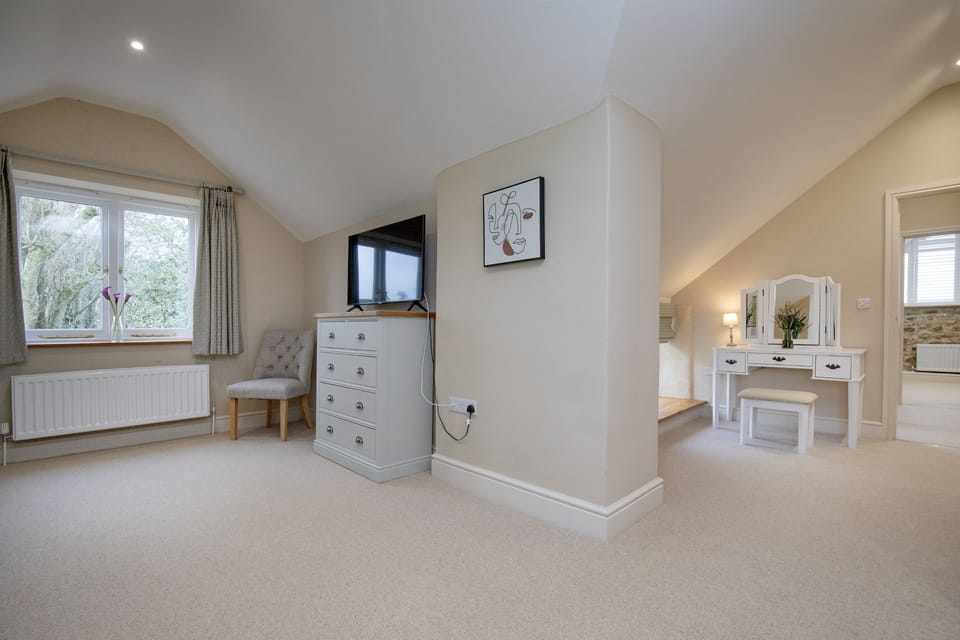 The Barn, Dorset: The sitting area leading to the dressing area and en-suite bathroom
