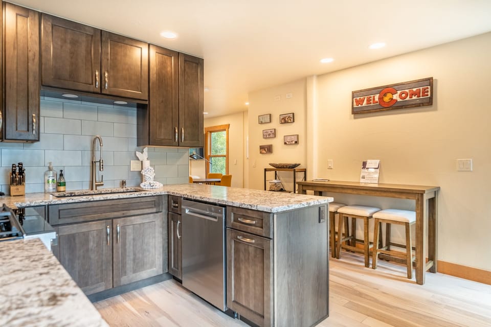 Full size kitchen featuring a breakfast bar with seating for 3.
