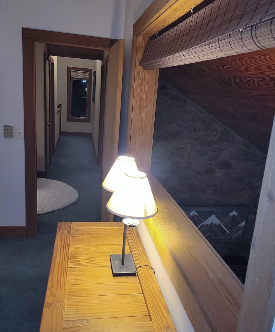 window in bedroom 2 that overlooks the living room when the shade is drawn