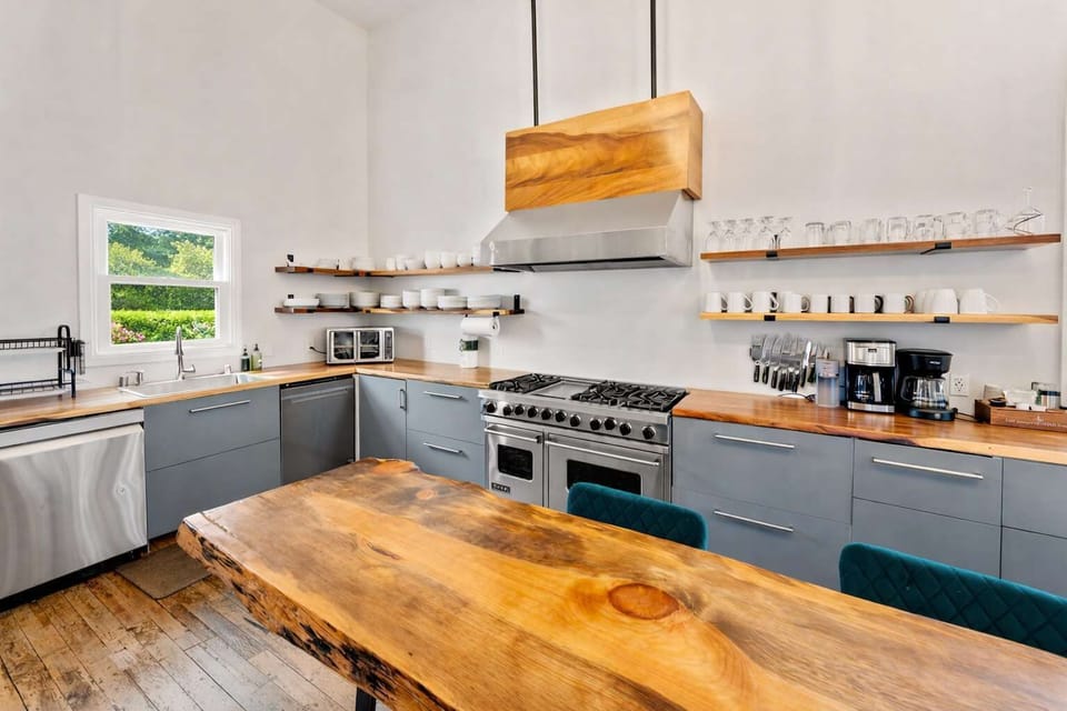 Open-Concept Chef’s Kitchen with Custom Wood Island, Premium Appliances, and Open Shelving — Warm, Functional, and Perfectly Designed