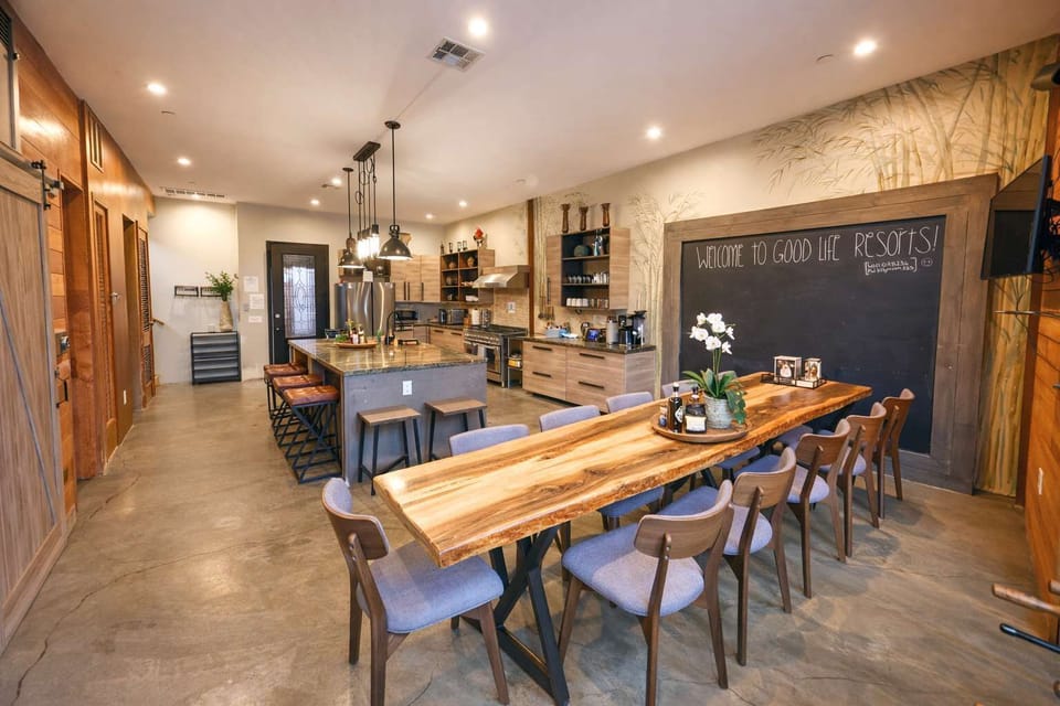 Modern Communal Dining Space – Long Rustic Table, Industrial-Chic Design, and Open Views into the Tropical Courtyard Perfect for Group Meals & Social Gatherings