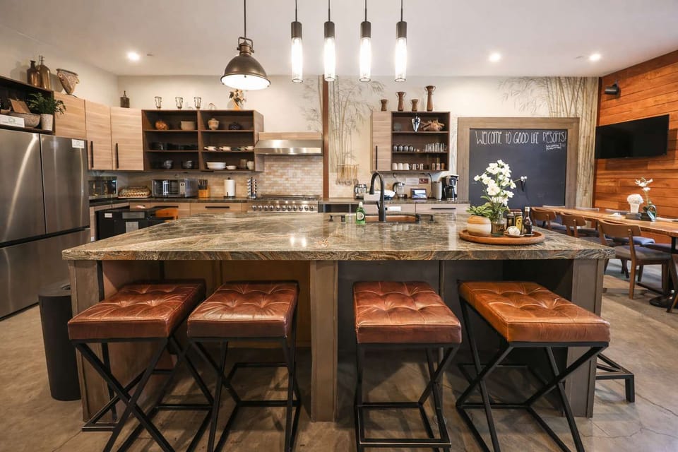 Modern Rustic Kitchen & Dining Area – Spacious Island Seating, Warm Wood Accents, and Open-Concept Design Perfect for Cooking, Entertaining & Group Gatherings
