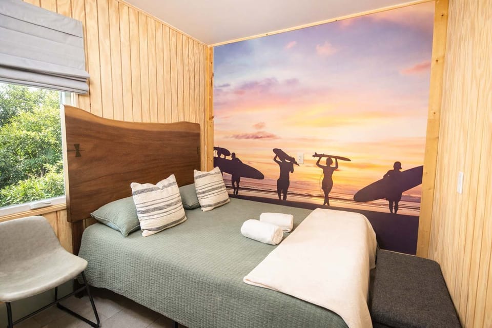 Serene Bedroom with Beach-Inspired Wall Art and Warm Coastal Vibes