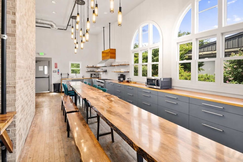 Long Communal-Style Kitchen Table with Natural Light, Modern Finishes, and Ample Seating — Ideal for Casual Dining and Easy Entertaining