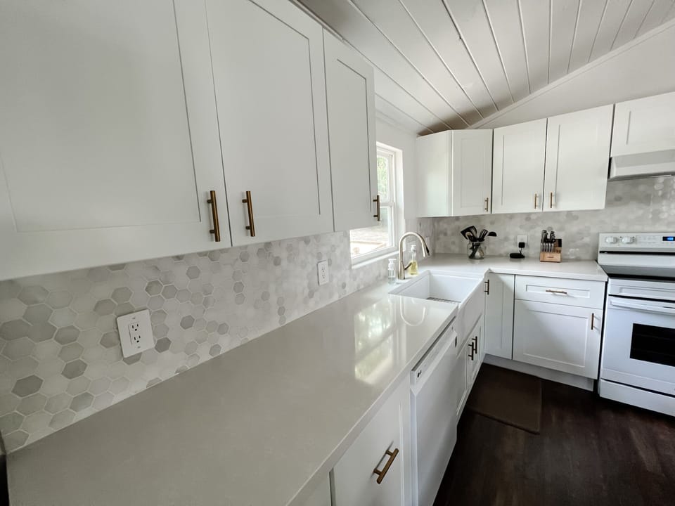 Beautiful white quartz countertops with gold accents. 