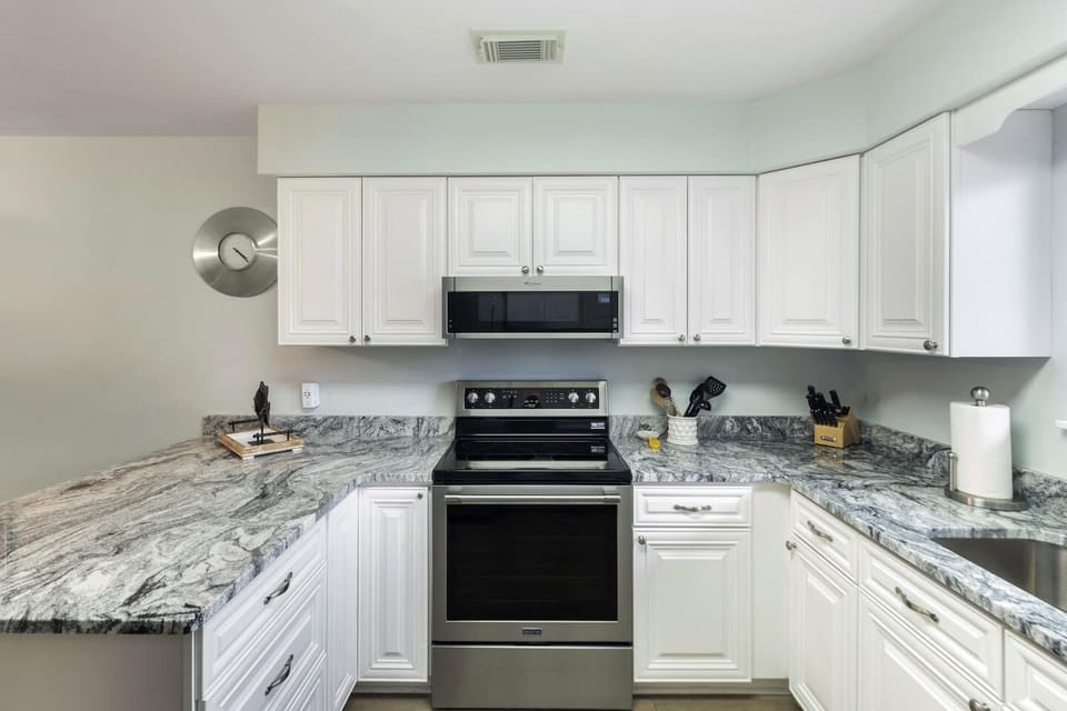 Spread out on the granite counter and cook like you mean it — this kitchen is ready for a week of home cooking.