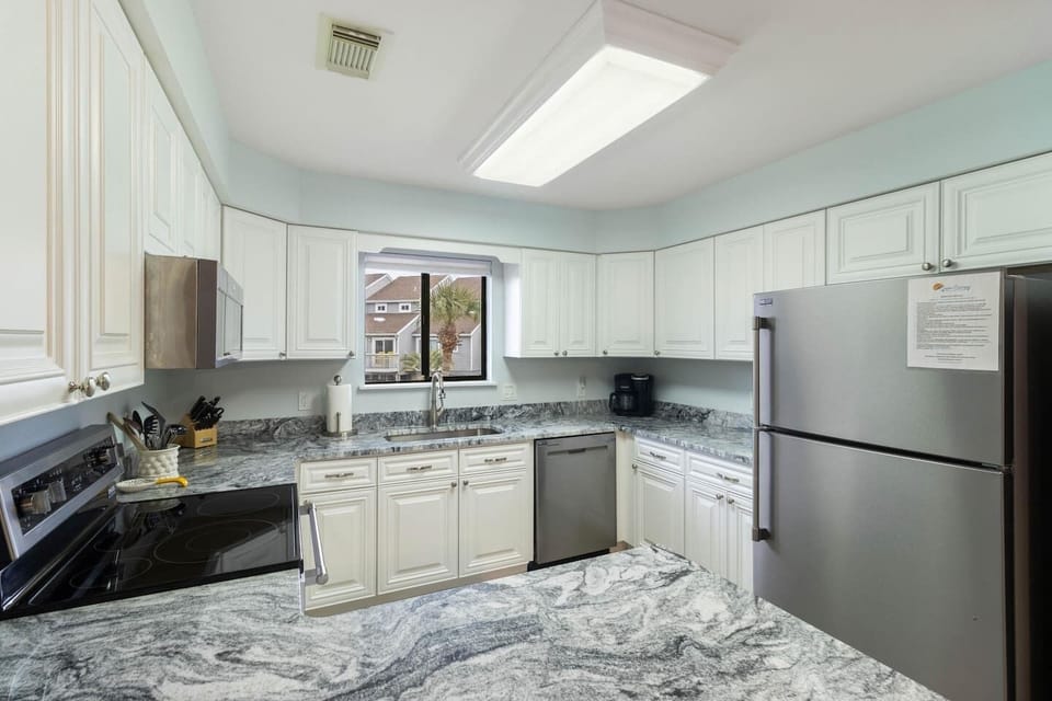 Cook a real vacation meal in this fully equipped kitchen — stainless appliances, everything you need already here.