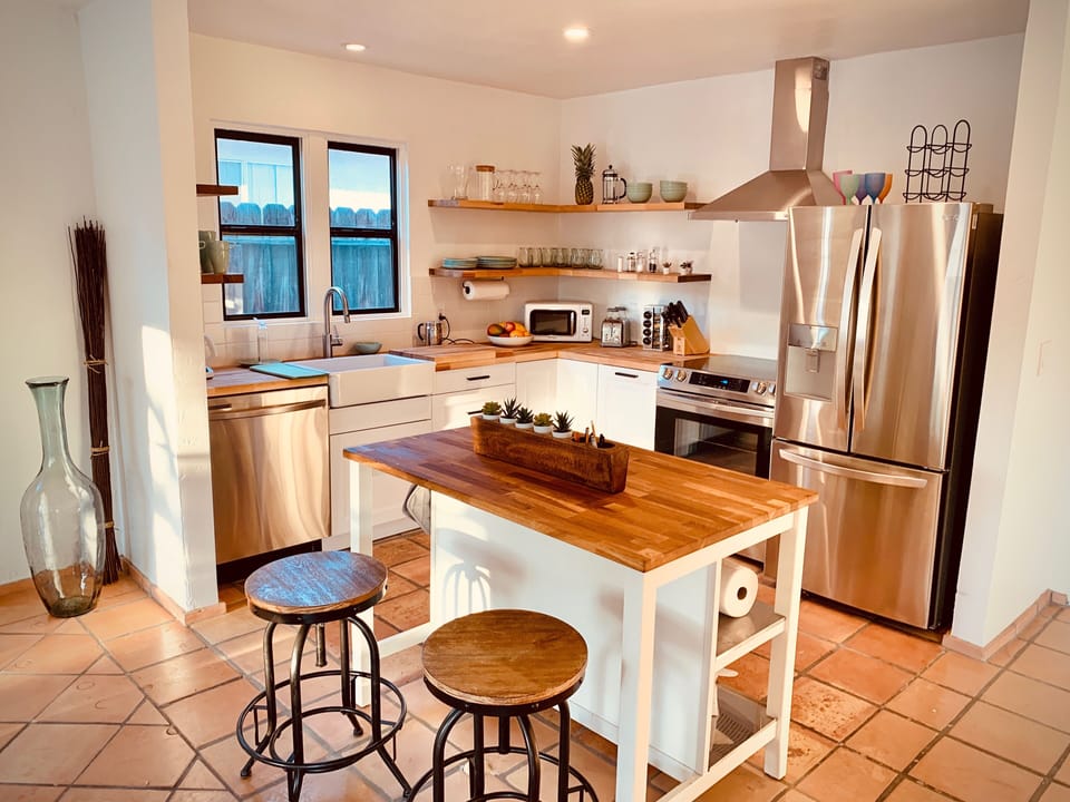 Open Entertainers kitchen with French door refrigerator 