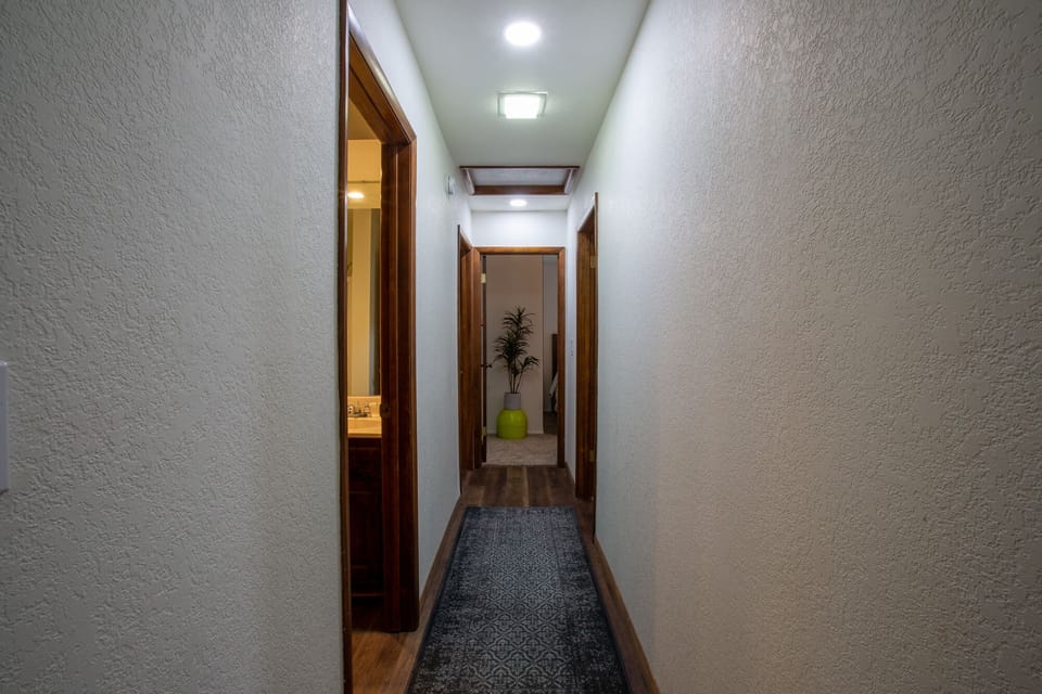 Hallway to shared bathroom and bedrooms