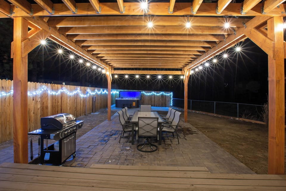 Huge outdoor table with plenty of seating on patio with BBQ at Under the Stars!