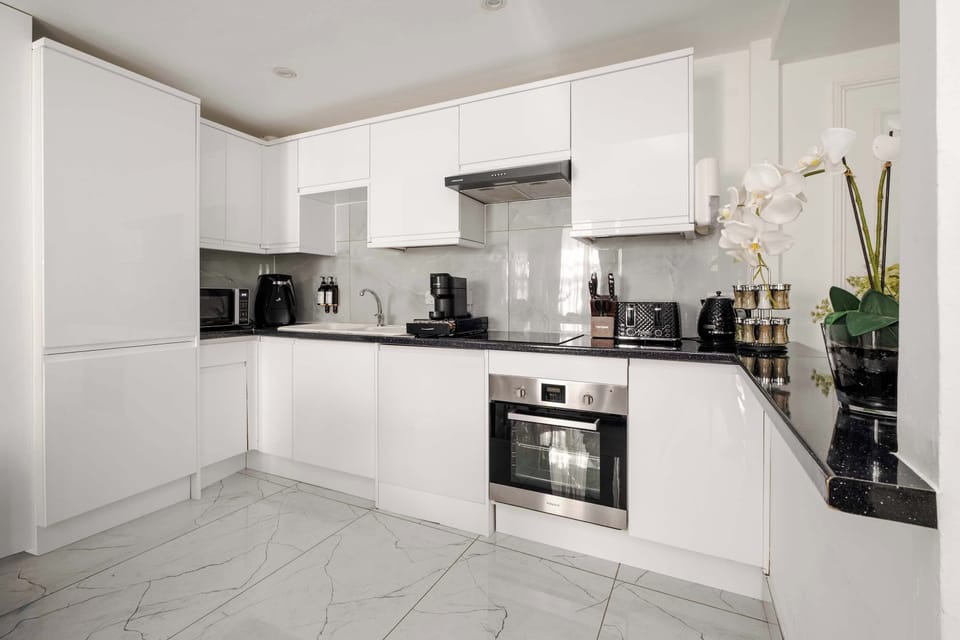 Full Kitchen | Our fully equipped kitchen boasts a range of modern conveniences, including a washing machine, dryer, microwave, espresso machine, and a fresh water dispenser, ensuring optimal convenience for all your culinary needs.