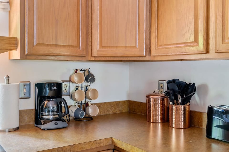 Fully-stocked kitchen with a stove/oven, and microwave