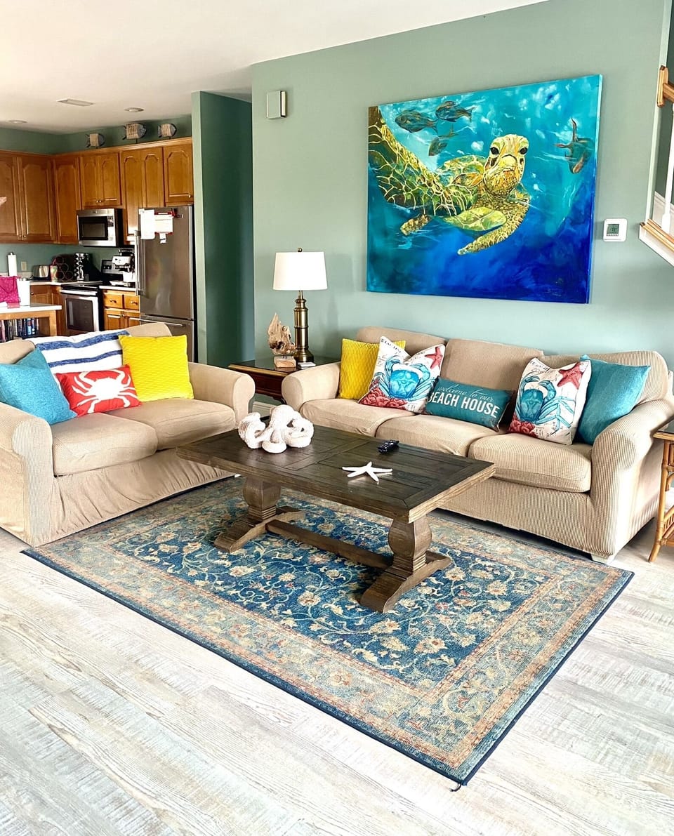 Ample seating in the living room featuring a new 65” smart tv