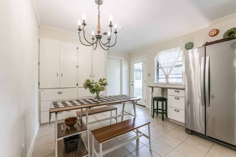 Kitchen layout w/ pantry/cabinet behind dining table. Rear is the laundry room. 