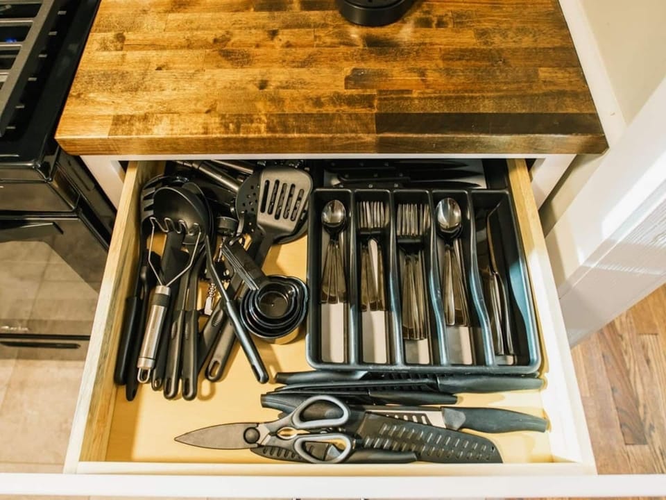 Full assortment of silverware, cutlery, and kitchen tools.