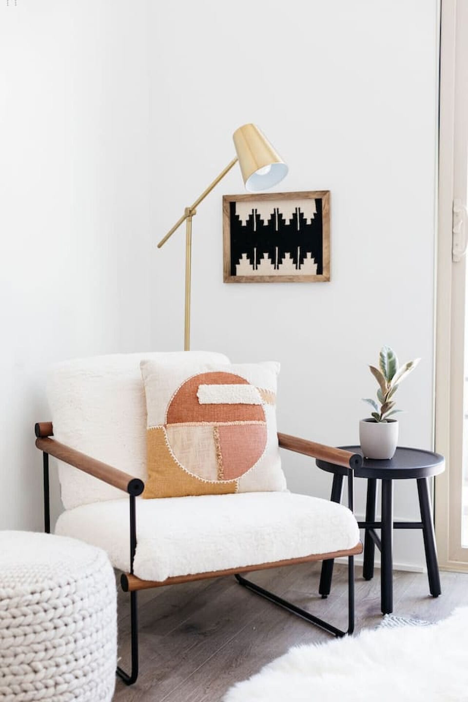 Minimal reading corner w/ cushioned chair, side table & simple decor