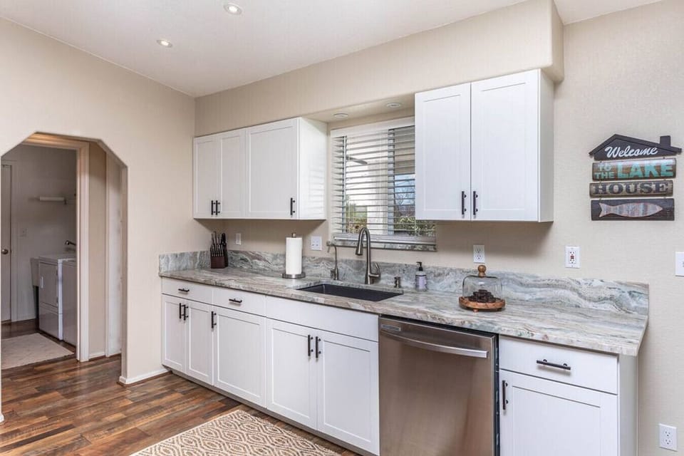 Fully stocked kitchen with modern appliances.