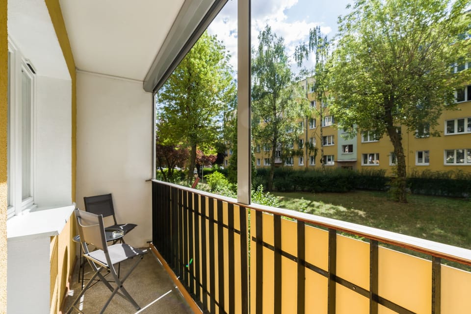 The balcony again, captured at a different angle, showcasing the surrounding greenery and relaxation setup.

