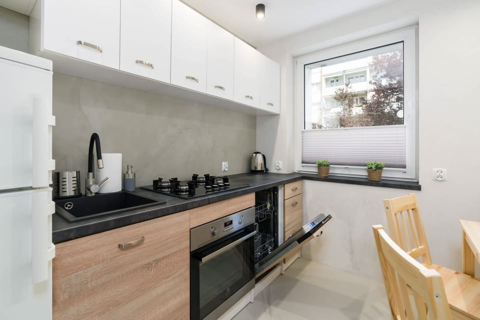 Another angle of the kitchen, emphasizing its modern appliances and dining setup.
