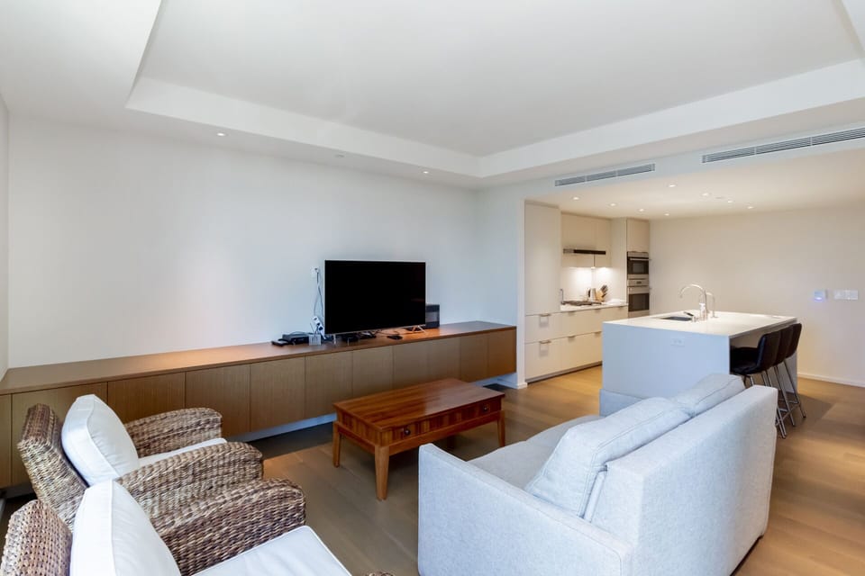 Living Room - Elegantly furnished living area with sofa, two lounge chairs and flat-screen tv to enjoy and relax.